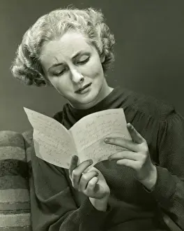 Woman reads distressing letter