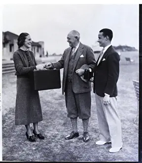 Prize Prints: Woman Receives Briefcase with Prize