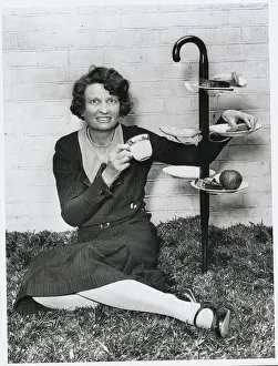 Woman Reclining in Picnic Fashion with New Utensil