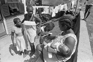 Grenada Prints: Woman Relaxes with Children on Porch