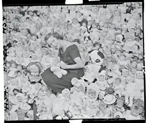 Woman in a Room of Dolls