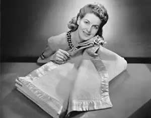 Woman rubbing blanket against her cheek