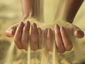Woman┬┤s hands holding sand