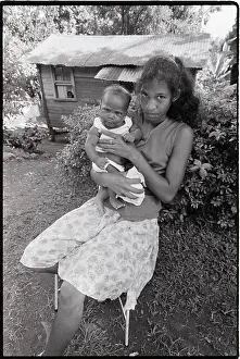 Grenada Prints: Woman Seated with Baby in Front of Home