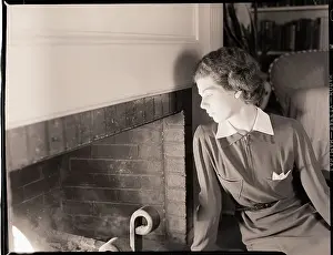 Woman Seated by Fireplace