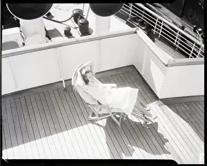 Overhead Prints: Woman Seated on Lounge Chair on Deck of Ship