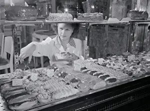 Woman Selecting French Pastries from Display