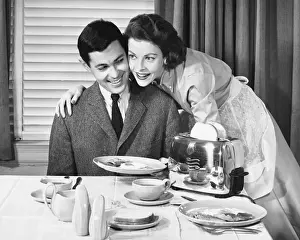 Mid Adult Couple Prints: Woman serving a man breakfast