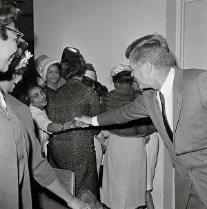 Woman Shaking Hands with JFK Across Crowd