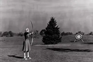 Vintage Black And White Prints: Woman Shooting Arrow at Archery Target