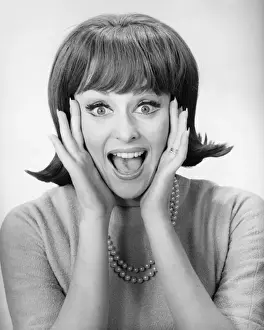 Woman shouting in studio, (B&W), portrait