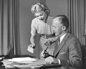Formal Businesswear Prints: Woman showing man cheque, man holding pen