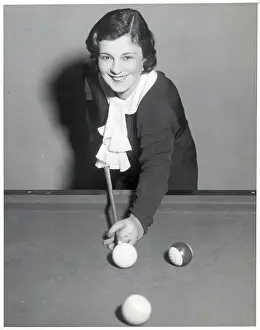 Woman Shown Playing Billiards