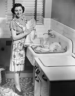 Woman at sink washing dishes