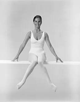 Images Dated 30th July 2011: Woman sitting on balance beam, smiling
