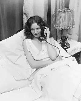 One Mature Woman Only Prints: Woman sitting in bed, talking on phone