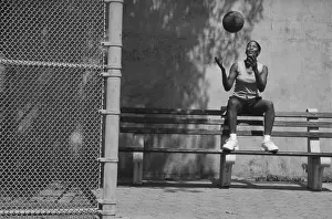 Prints of Vintage Black and White, AB24978 Stockbyte Prints: Woman sitting on bench tossing basketball in air (B&W)