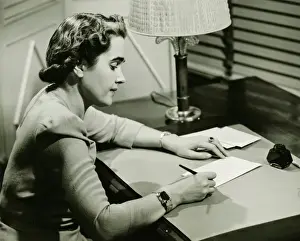 40 49 Years Prints: Woman sitting at desk, writing, (B&W)