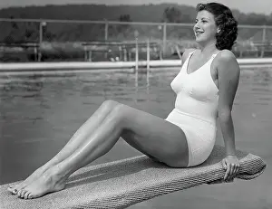 Woman sitting on divingboard