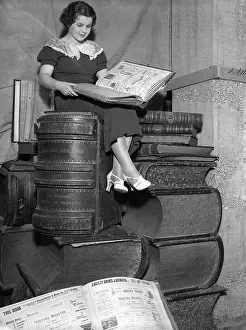 Giant Prints: Woman sitting on giant books