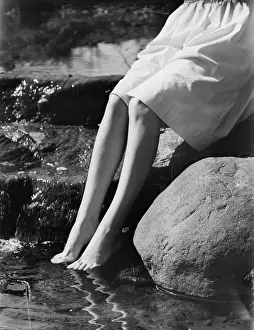 Ankle Deep In Water Prints: Woman sitting on rock with feet in water, low section