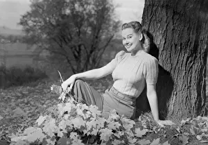 Hair Back Prints: Woman sitting beside tree, portrait