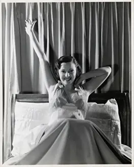 Nightgown Prints: Woman Smiling and Stretching in Bed