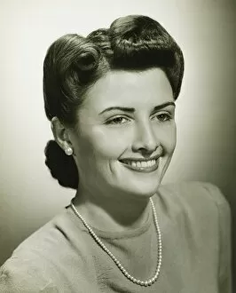 Pearl Collection: Woman smiling in studio, (B&W), close-up