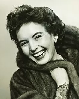 Pearl Collection: Woman smiling in studio, (B&W), portrait