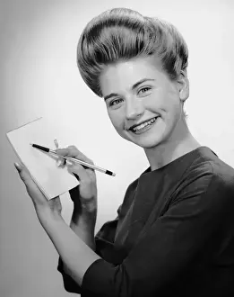 Woman smiling w / pen & pad