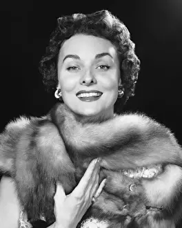 Woman smiling, wearing fur stole