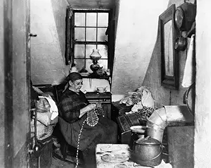 Tenement House Prints: Woman Smoking Pipe & Doing Handiwork