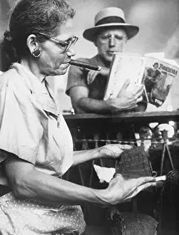 Rolling Prints: Woman Smoking and Rolling Cigars at Factory
