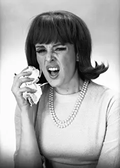 Woman sneezing in studio, (B&W)