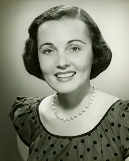Polka Dot Prints: Woman in spotted dress posing in studio, (B&W), (Close-up), (Portrait)
