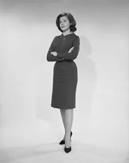 1960s Fashion Gallery: Woman standing with arms crossed, studio shot