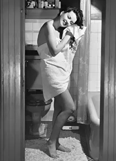 Towel Prints: Woman standing in bathroom, wrapped in towel