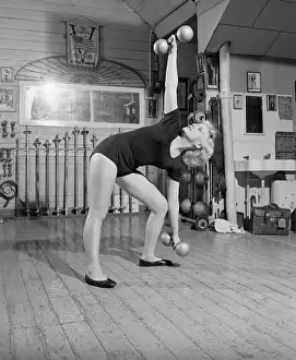 Gymnasium Prints: Woman Standing Exercising With Barbells