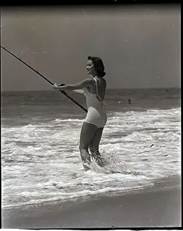 Woman Standing in Surf to Fish