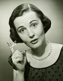 String Prints: Woman with string tied around finger in studio, (B&W), (Close-up), (Portrait)