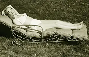 Eyewear Prints: Woman sun tanning on meadow, (B&W), elevated view