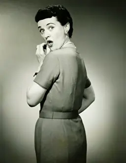 Woman with surprised look in studio, (B&W), portrait
