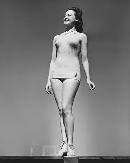 Wavy Hair Prints: Woman in swimsuit posing in studio (B&W), low angle view