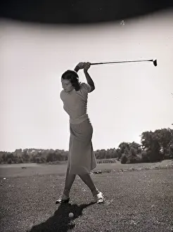 Woman Swinging a Golf Club