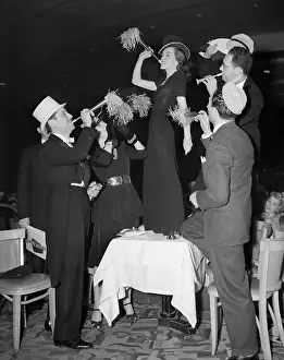 Trumpet Prints: Woman on Table Blowing Noisemaker