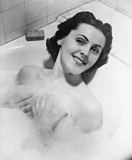 Foam Gallery: Woman taking bath in bathtub (B&W), portrait