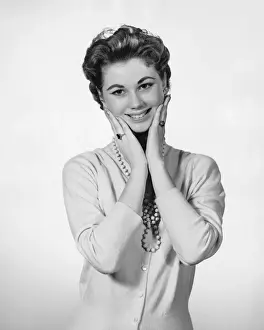 Woman touching face, looking surprised