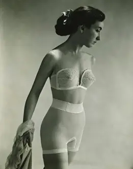 Woman in underwear posing in studio, (B&W), portrait