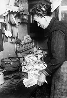 Kitchen Prints: Woman Using Paper Money to Light Stove