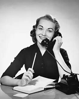 Using Phone Prints: Woman using phone and holding pencil